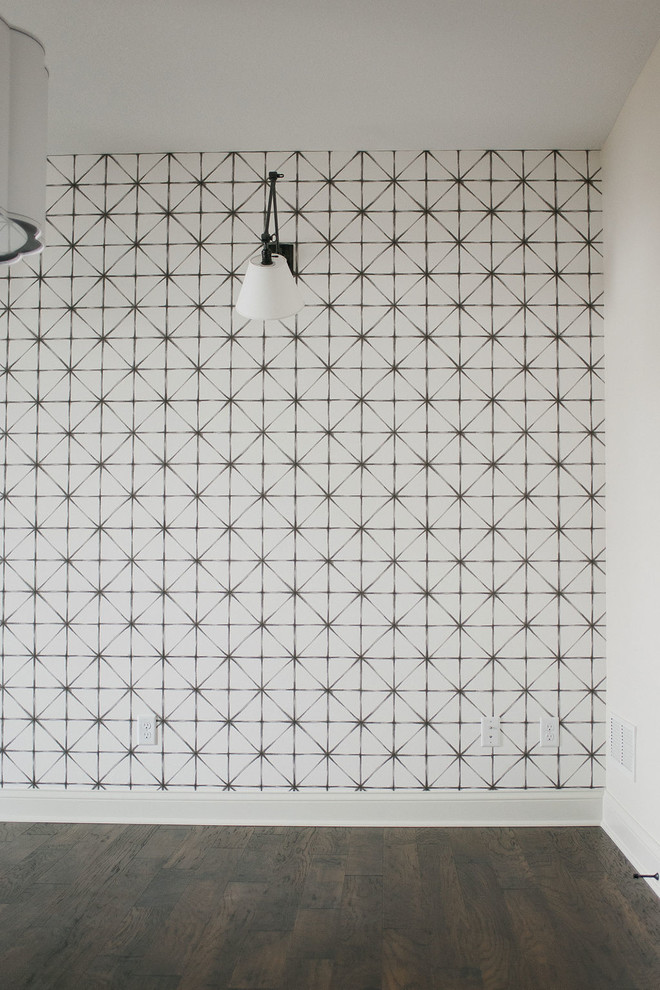 Example of a mid-sized minimalist dark wood floor and brown floor home office design in Minneapolis with white walls