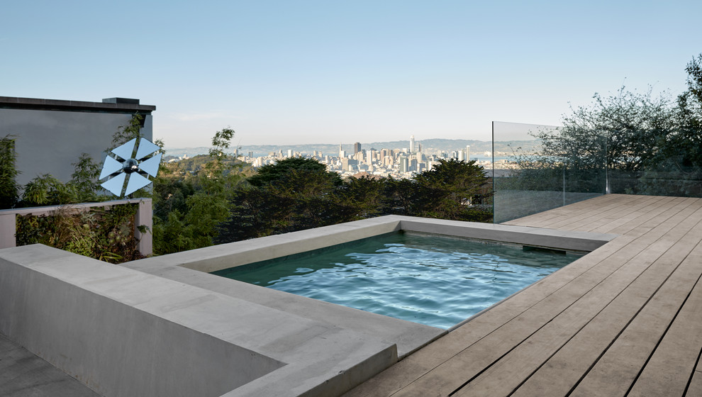 Small modern backyard rectangular aboveground pool in San Francisco with a hot tub and decking.