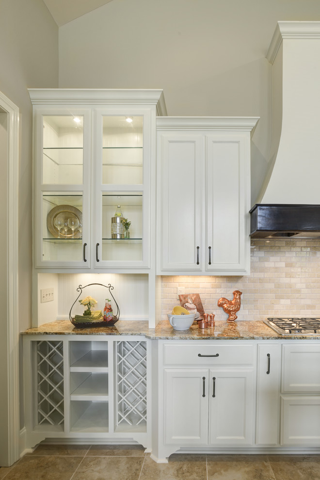 Photo of a mid-sized transitional u-shaped eat-in kitchen in New Orleans with recessed-panel cabinets, white cabinets, granite benchtops, beige splashback, porcelain splashback, stainless steel appliances, dark hardwood floors, with island, beige floor and beige benchtop.