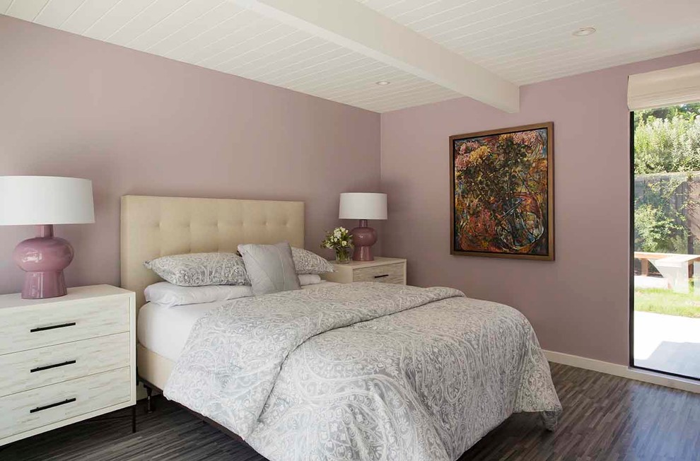 This is an example of a mid-sized midcentury master bedroom in San Francisco with purple walls, light hardwood floors and no fireplace.