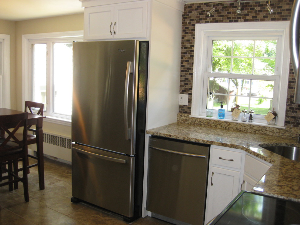 Example of a small transitional l-shaped porcelain tile and brown floor kitchen design in Boston with an undermount sink, recessed-panel cabinets, white cabinets, granite countertops, brown backsplash, stainless steel appliances, no island, glass tile backsplash and beige countertops