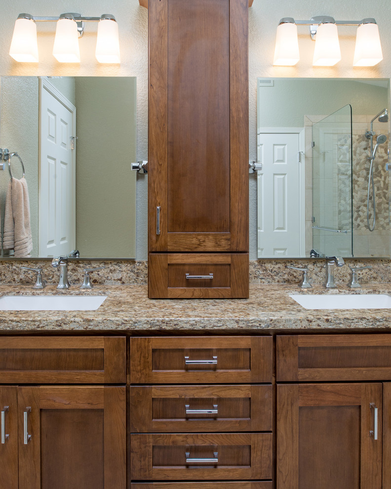 This is an example of a mid-sized traditional master bathroom in San Diego with an undermount sink, raised-panel cabinets, medium wood cabinets, granite benchtops, a drop-in tub, an open shower, a one-piece toilet, beige tile, ceramic tile, beige walls and ceramic floors.