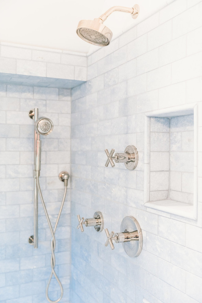 Photo of a mid-sized transitional master bathroom in Baltimore with recessed-panel cabinets, blue cabinets, a japanese tub, a corner shower, a one-piece toilet, blue tile, marble, white walls, mosaic tile floors, a drop-in sink, marble benchtops, blue floor and a hinged shower door.