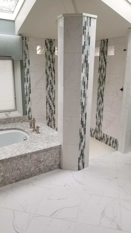 Doorless shower - large transitional master white tile and porcelain tile porcelain tile and white floor doorless shower idea with flat-panel cabinets, white cabinets, an undermount tub, gray walls, an undermount sink, solid surface countertops and gray countertops