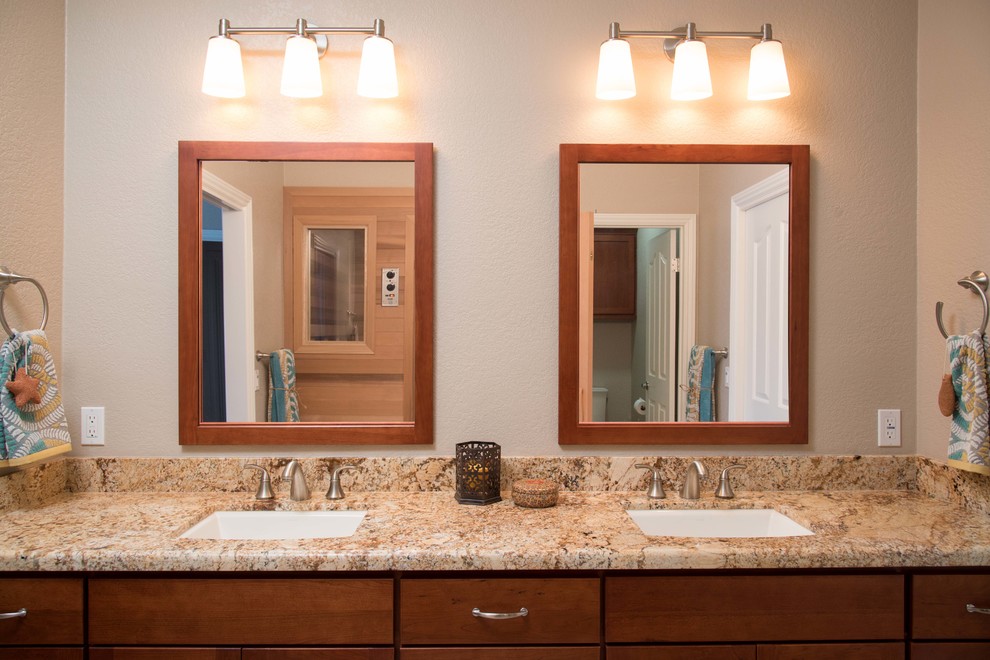 This is an example of a mid-sized traditional bathroom in San Diego with an undermount sink, shaker cabinets, medium wood cabinets, engineered quartz benchtops, a one-piece toilet, beige tile, porcelain tile, beige walls, porcelain floors and with a sauna.