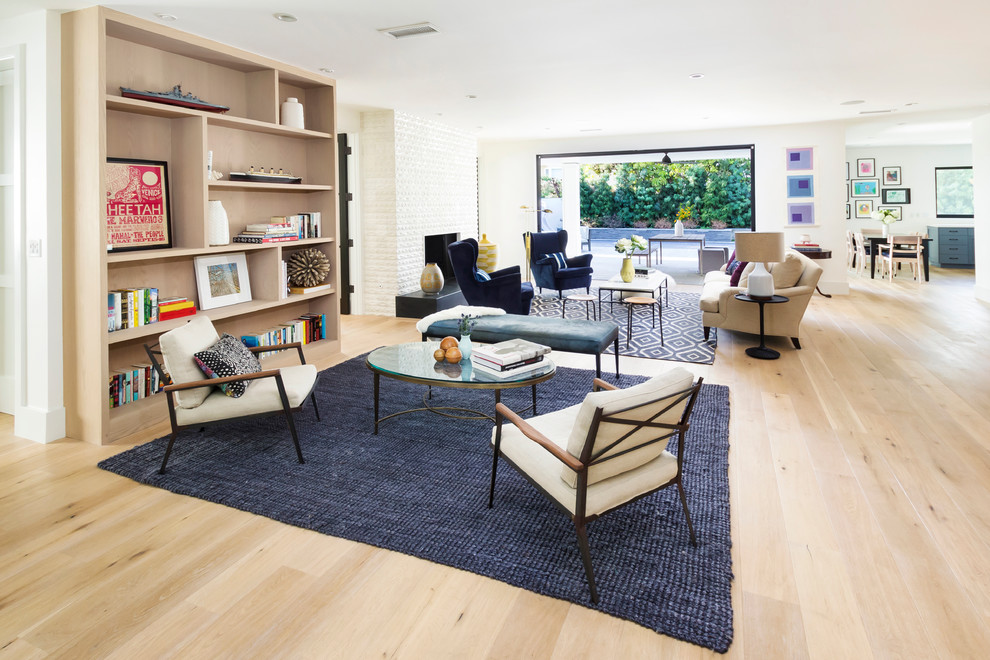 This is an example of a transitional living room in Los Angeles with white walls and beige floor.
