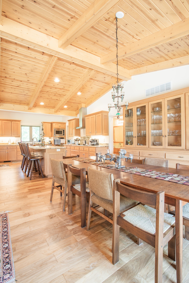 Open concept kitchen - large transitional u-shaped light wood floor and beige floor open concept kitchen idea with an undermount sink, shaker cabinets, light wood cabinets, granite countertops, stainless steel appliances, an island and brown countertops