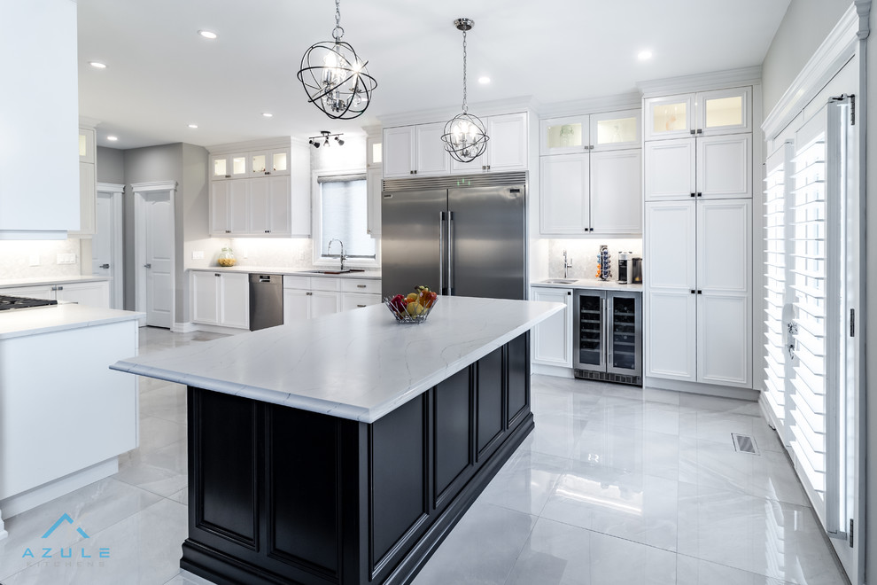 Large transitional u-shaped porcelain tile enclosed kitchen photo with recessed-panel cabinets, white cabinets, quartz countertops, white backsplash, marble backsplash, stainless steel appliances, an island and white countertops