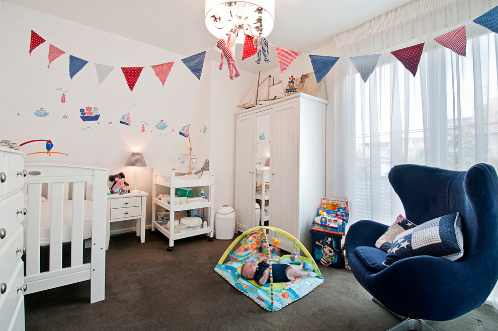 Large traditional gender-neutral nursery in Melbourne with white walls, carpet and brown floor.