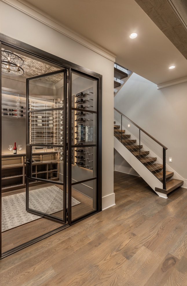Inspiration for a country wine cellar in Other with light hardwood floors and display racks.