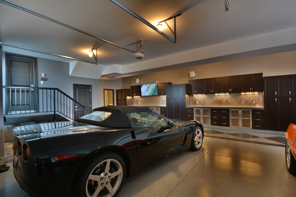 Inspiration for an expansive industrial attached three-car garage in Edmonton.