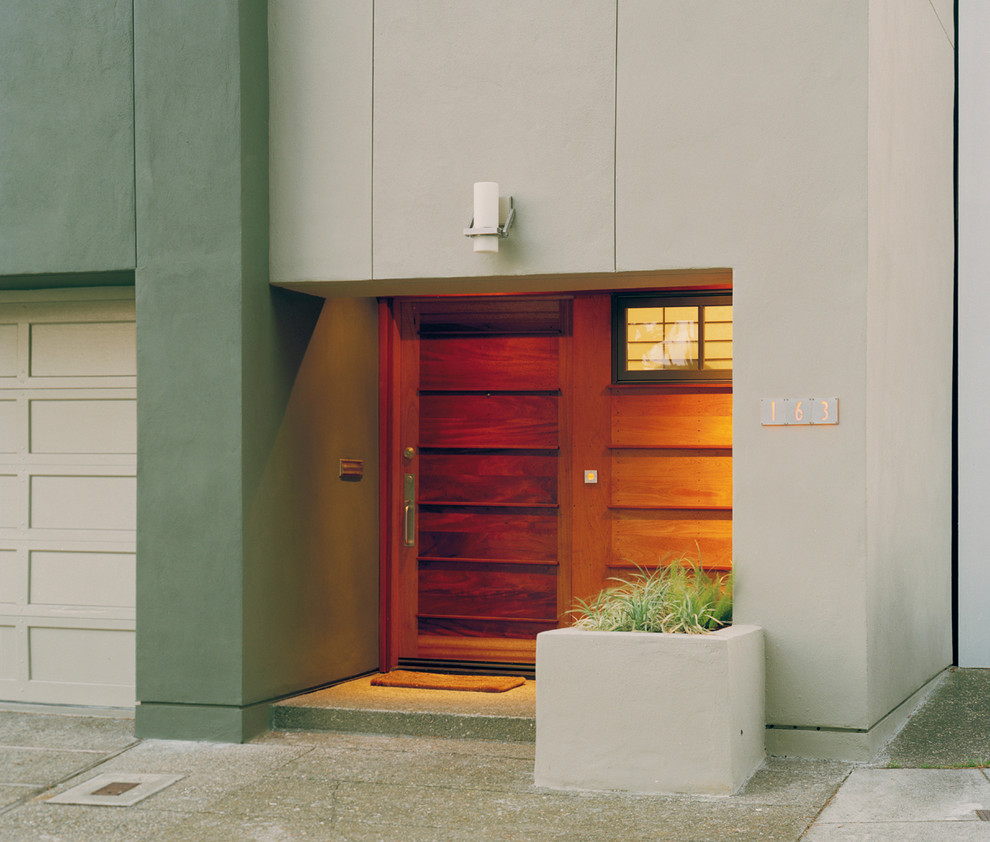 Small modern front door in San Francisco with concrete floors, a single front door, a medium wood front door, green walls and grey floor.