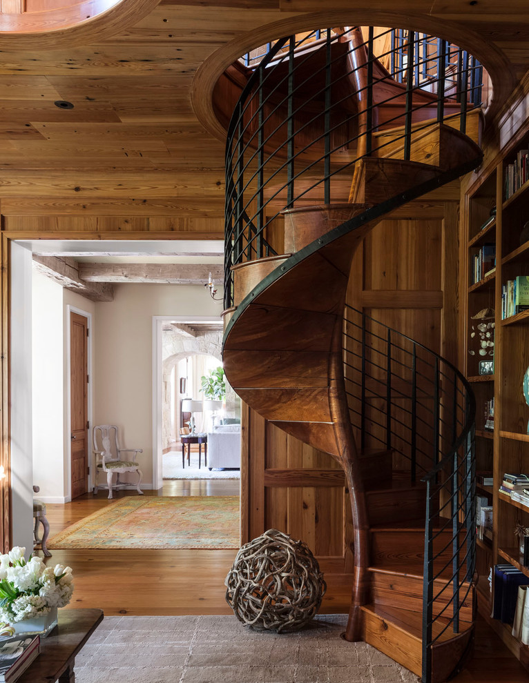Photo of a transitional wood spiral staircase in Dallas with wood risers.