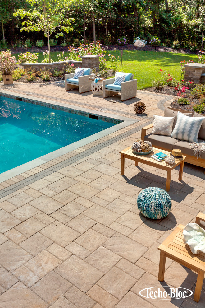 Inspiration for a modern backyard l-shaped pool in New York with concrete pavers.