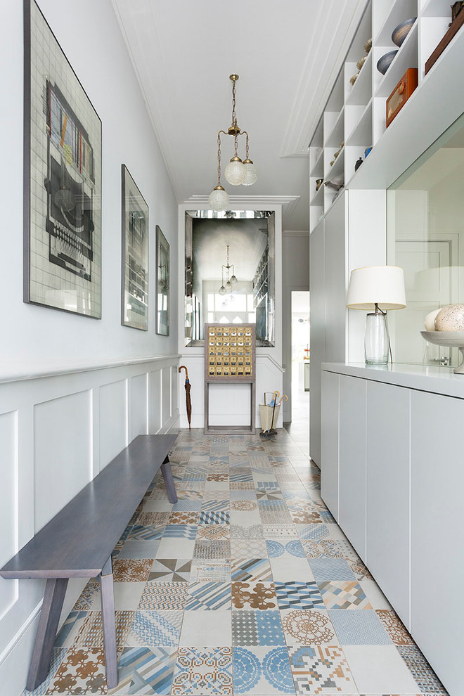 Inspiration for a contemporary hallway in London with white walls and multi-coloured floor.