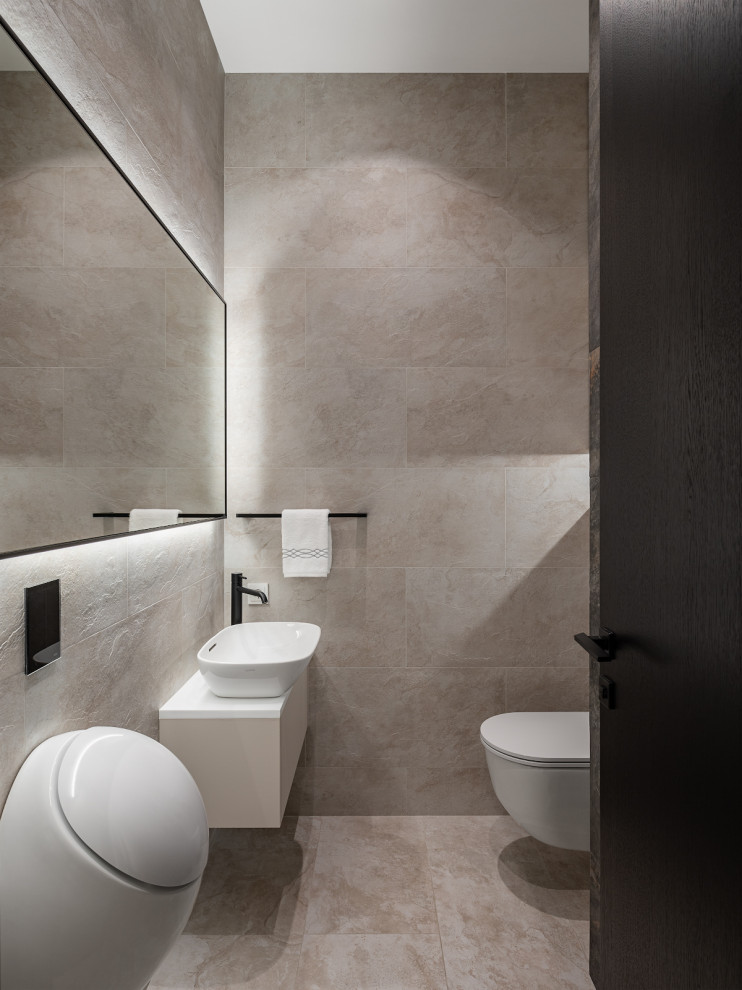 Design ideas for a medium sized contemporary cloakroom in Moscow with flat-panel cabinets, beige cabinets, an urinal, beige tiles, porcelain tiles, beige walls, porcelain flooring, a vessel sink, solid surface worktops, beige floors, white worktops and a floating vanity unit.