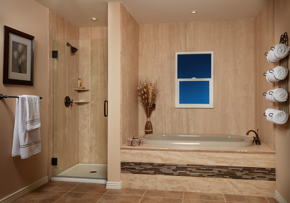 Mediterranean master bathroom in Bridgeport with an alcove tub, an alcove shower, beige tile, brown tile, orange tile, orange walls, terra-cotta floors, orange floor and a hinged shower door.