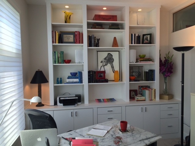 Mid-sized contemporary study room in Cleveland with beige walls, carpet, no fireplace and a freestanding desk.