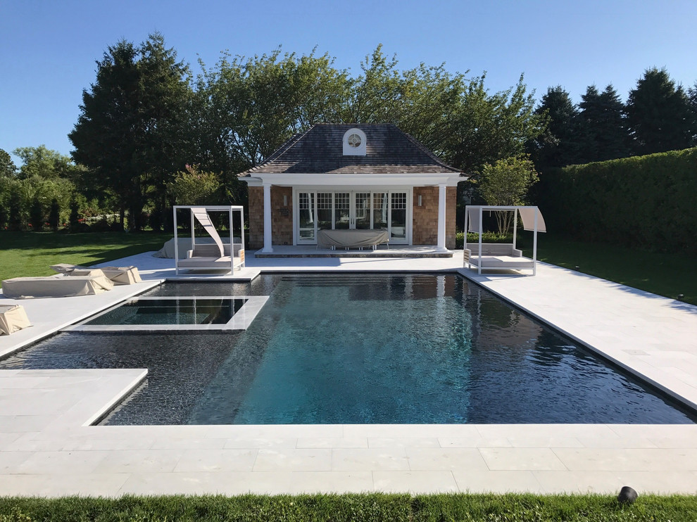 Inspiration for a large backyard stone and custom-shaped aboveground pool house remodel in New York