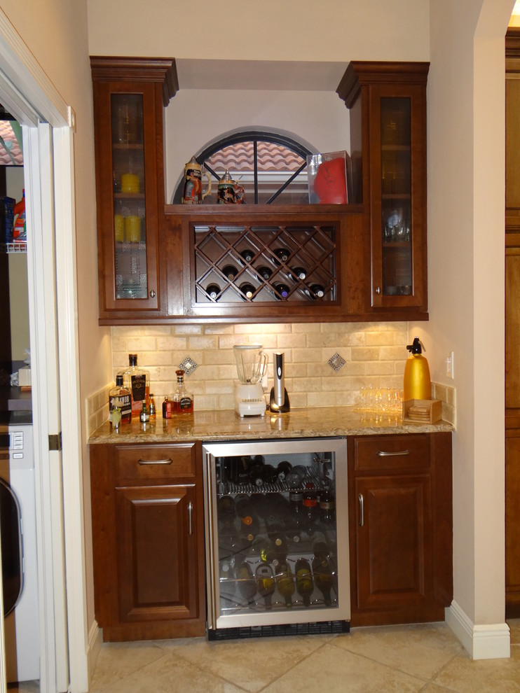 Wine cellar - small traditional ceramic tile wine cellar idea in Tampa with display racks