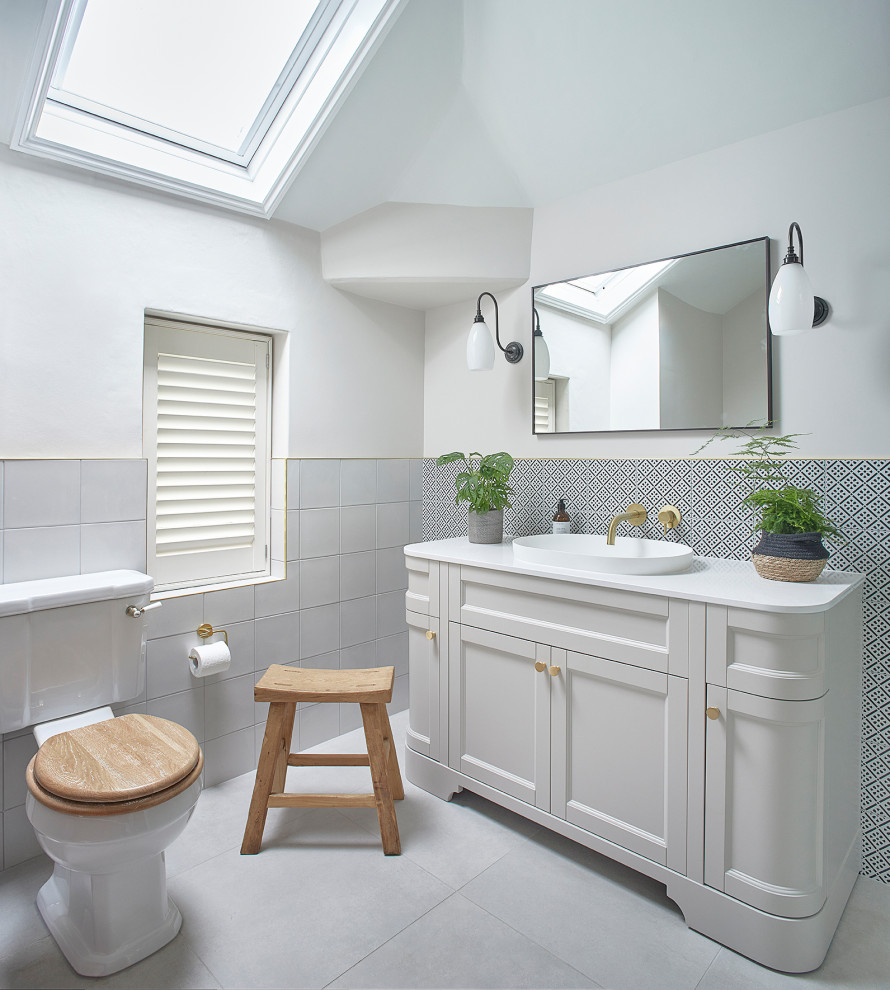 Design ideas for a traditional bathroom in Oxfordshire with recessed-panel cabinets, grey cabinets, white tiles, white walls, a vessel sink, grey floors, white worktops, a single sink and a freestanding vanity unit.