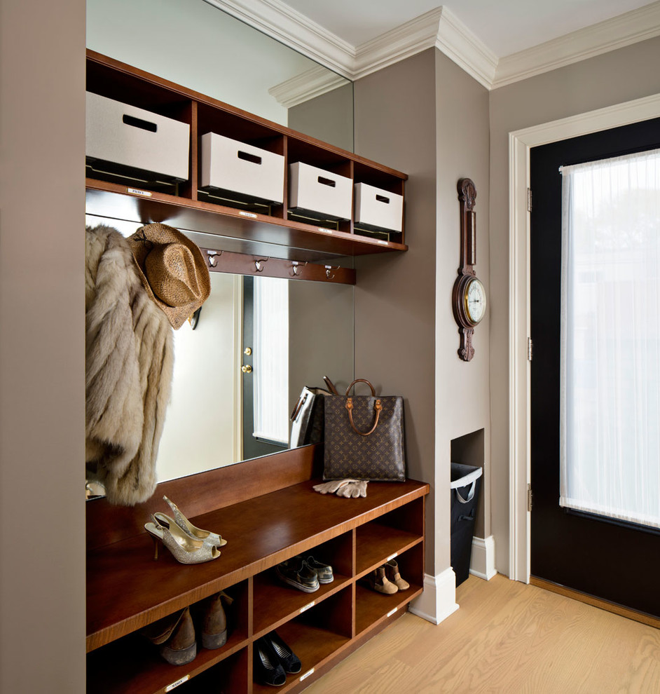Inspiration for a mid-sized transitional mudroom in Chicago with purple walls and light hardwood floors.