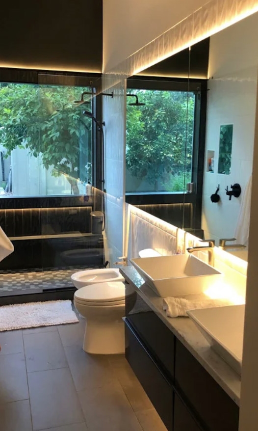Medium sized modern grey and black ensuite bathroom in Phoenix with flat-panel cabinets, grey cabinets, black and white tiles, ceramic tiles, marble worktops, white floors, white worktops, feature lighting, double sinks, a floating vanity unit and a vaulted ceiling.