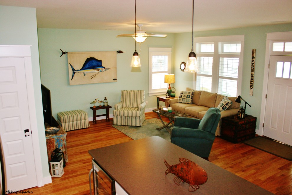 Mid-sized beach style living room in Other with grey walls and medium hardwood floors.