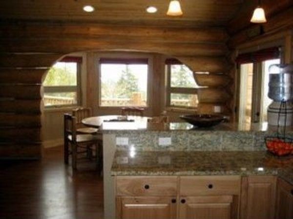 Example of a mid-sized mountain style l-shaped open concept kitchen design with recessed-panel cabinets and light wood cabinets