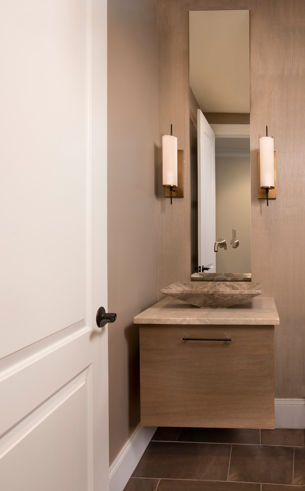 Inspiration for a small transitional powder room in Boston with flat-panel cabinets, medium wood cabinets, beige walls, slate floors, a vessel sink, limestone benchtops and brown floor.