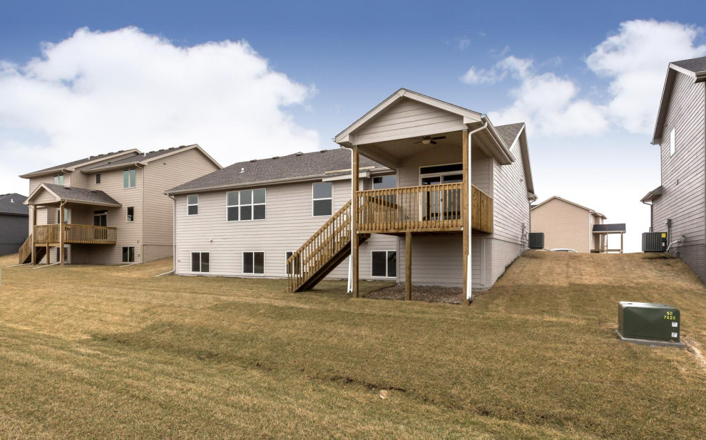 Large transitional gray one-story vinyl gable roof idea with a shingle roof