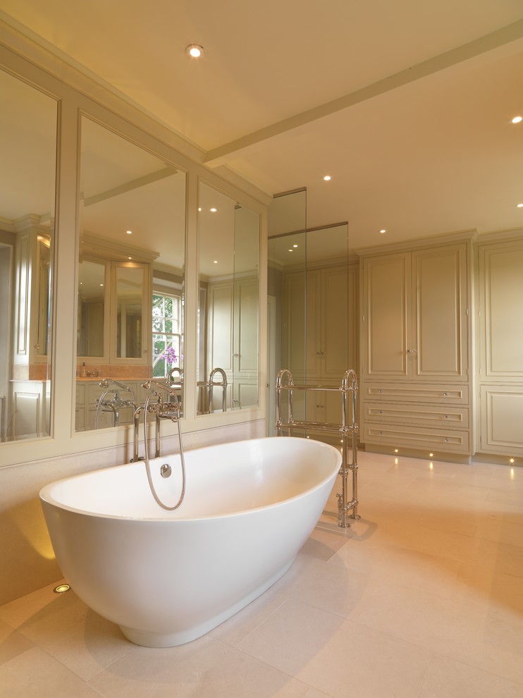 Large traditional master bathroom in Other with raised-panel cabinets, green cabinets, a freestanding tub, an open shower, a one-piece toilet, white tile, limestone, brown walls, limestone floors, an undermount sink, marble benchtops, white floor, an open shower, red benchtops, a single vanity, a freestanding vanity and panelled walls.