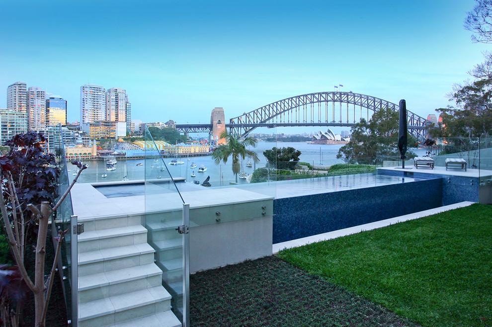 Mid-sized contemporary backyard rectangular aboveground pool in Sydney with a water feature.