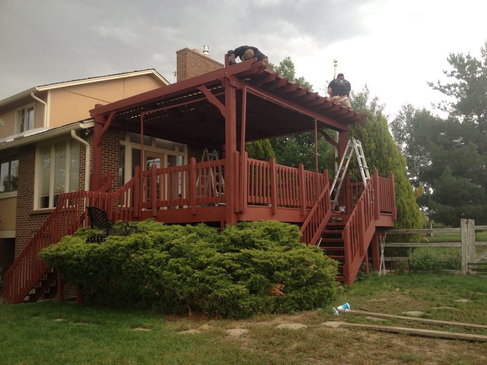 Inspiration for a large rustic balcony deck remodel in Denver with a pergola