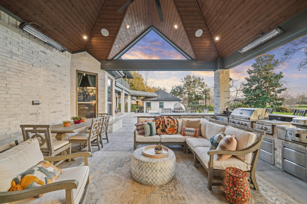 Design ideas for an american patio in Houston With an Outdoor Kitchen and a Roof Extension.