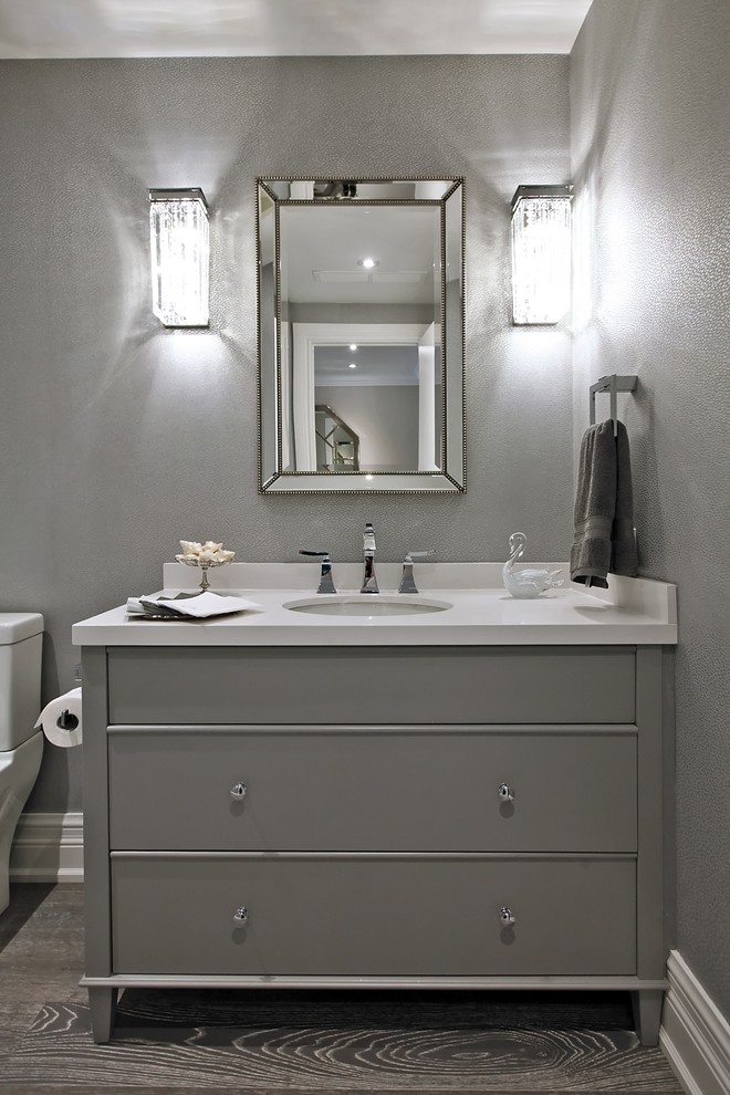 Inspiration for a mid-sized contemporary 3/4 bathroom in Toronto with shaker cabinets, white cabinets, a one-piece toilet, grey walls, dark hardwood floors, an undermount sink, solid surface benchtops and grey floor.