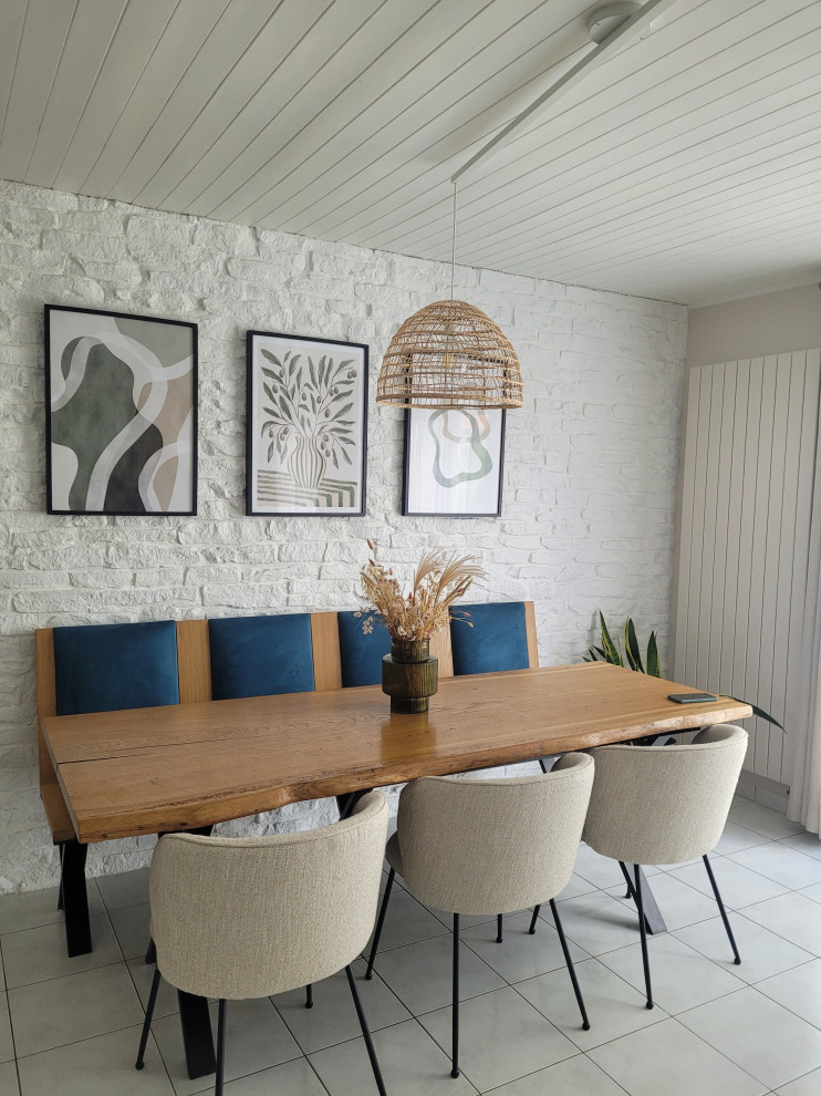 Photo of a scandinavian dining room in Other with beige walls, a timber clad ceiling and brick walls.