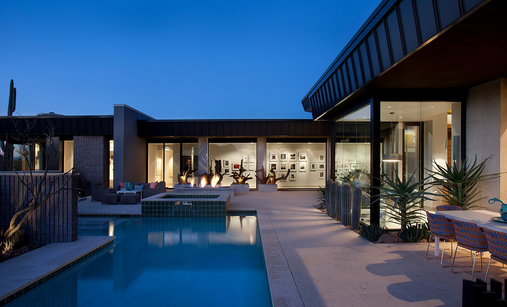 Inspiration for a large contemporary backyard l-shaped pool in Phoenix with a hot tub.
