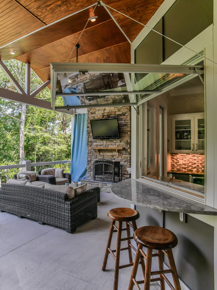 Inspiration for a large transitional backyard deck remodel with a fire pit and a roof extension