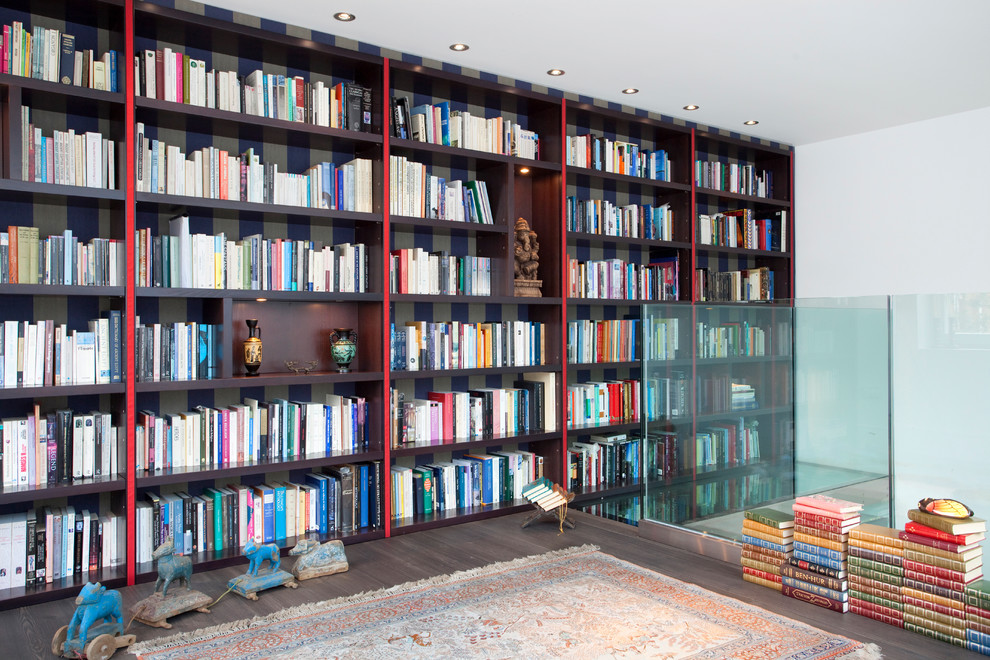 This is an example of a modern family room in London with a library.