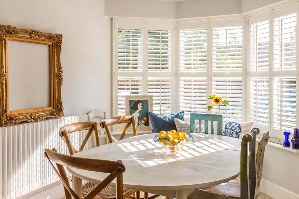 Design ideas for a country dining room in London with white walls.