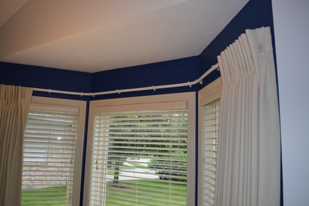 This is an example of a small traditional guest bedroom in Indianapolis with blue walls and carpet.