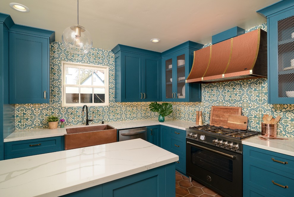 Design ideas for a mediterranean kitchen in Sacramento with shaker cabinets, turquoise cabinets, solid surface benchtops, terra-cotta floors, with island and white benchtop.