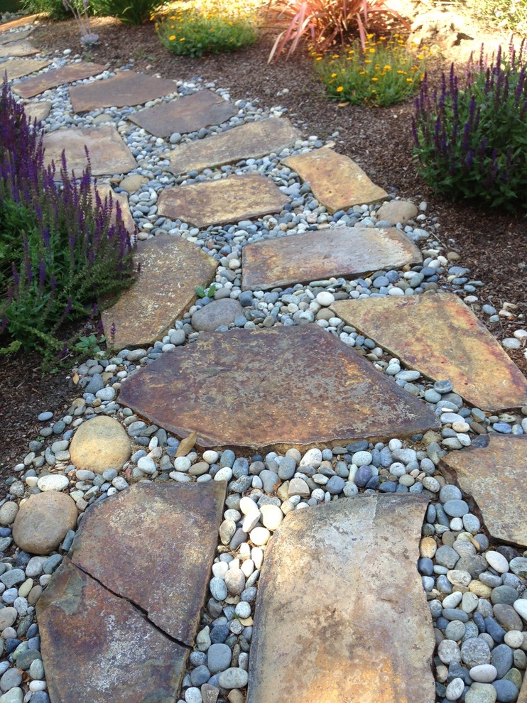 Photo of a small country front yard full sun garden in San Francisco with a garden path and natural stone pavers.