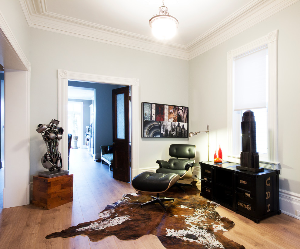 Inspiration for an eclectic living room in Toronto with white walls, light hardwood floors and no fireplace.