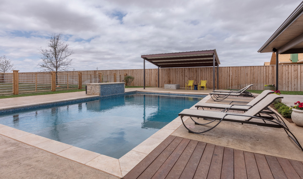 Inspiration for a large transitional backyard stamped concrete and rectangular lap hot tub remodel