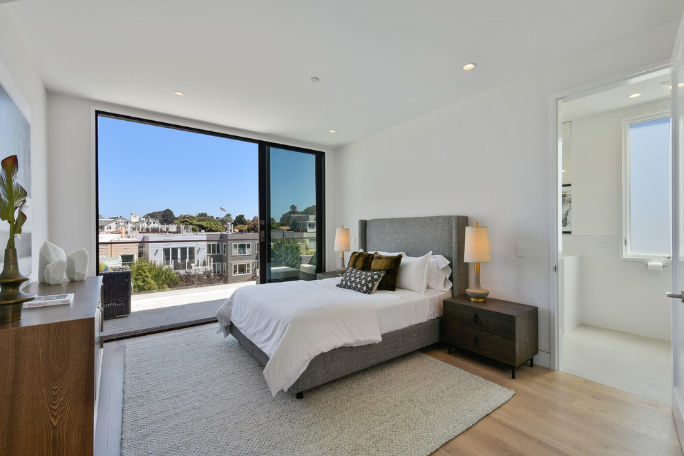 Inspiration for a contemporary master bedroom in San Francisco with white walls, medium hardwood floors and beige floor.