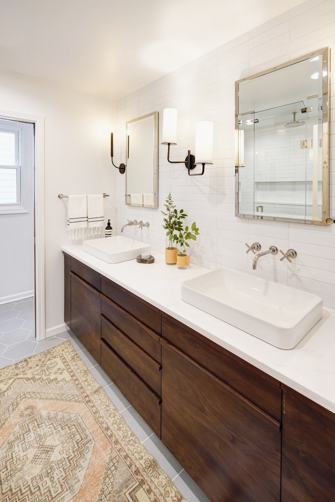 This is an example of a large contemporary master bathroom in Chicago with flat-panel cabinets, dark wood cabinets, white tile, porcelain tile, white walls, porcelain floors, a drop-in sink, engineered quartz benchtops and grey floor.