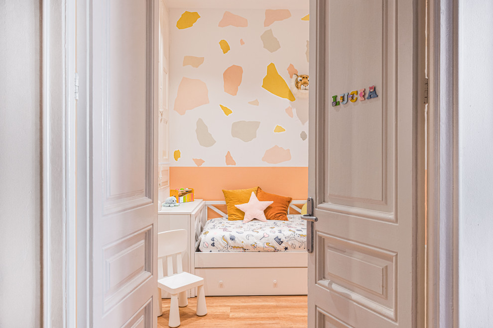 Design ideas for a mid-sized gender-neutral kids' bedroom for kids 4-10 years old in Barcelona with multi-coloured walls, vinyl floors and beige floor.