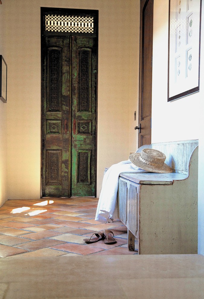 Design ideas for a transitional hallway in Los Angeles with white walls and terra-cotta floors.